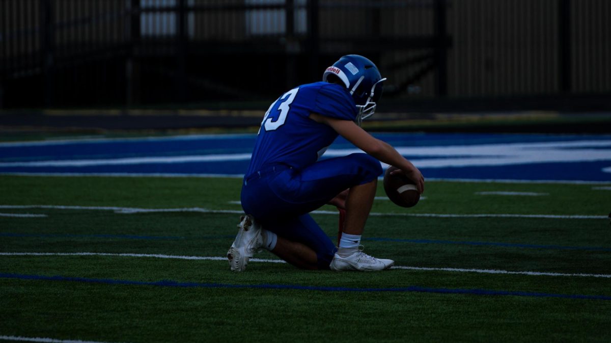 Ezek Soto sets up for a in the eighth grade blue and white football game
